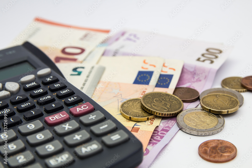 Euro Money banknote and coins with calculator isolated white background Euro Money banknote and coins with calculator isolated white background