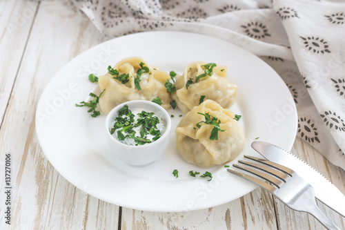 Traditional Turkish manti with sour cream sauce