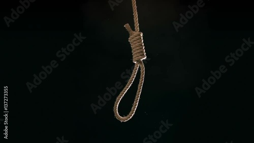 Hangmans noose falling into frame at 120 fps against black background