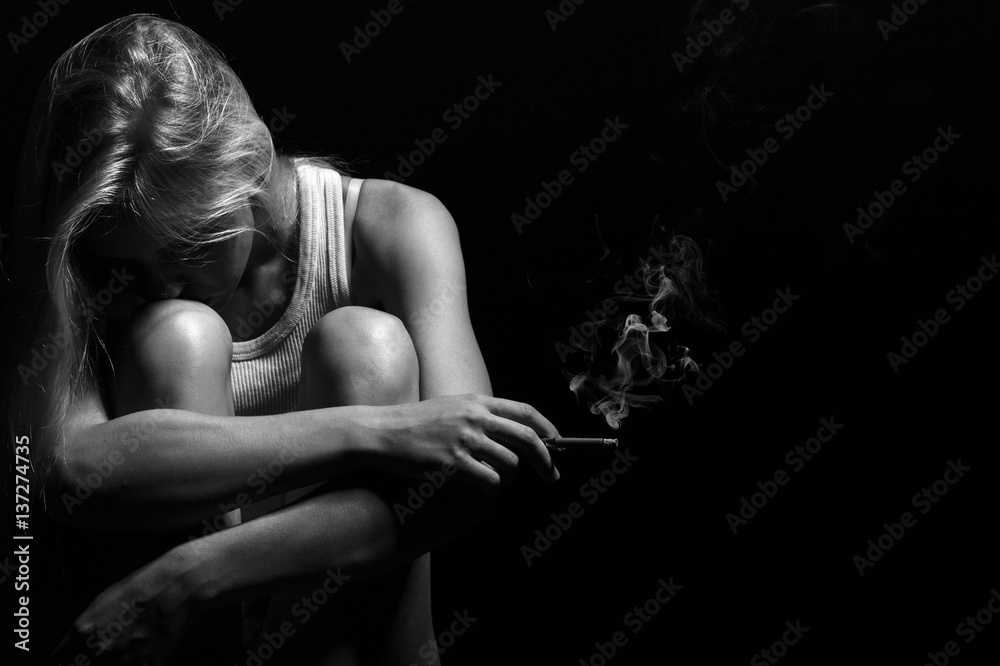 sad smoking blond girl on black background, monochrome Stock Photo | Adobe  Stock
