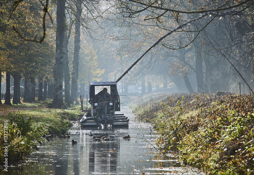 Canvas Print A dredger pumps silt and mud from a water channel
