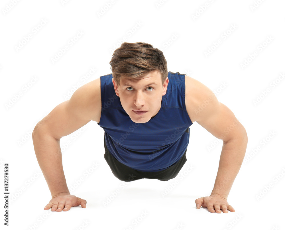 Young handsome sportsman doing exercises on white background Young handsome sportsman doing exercises on white background