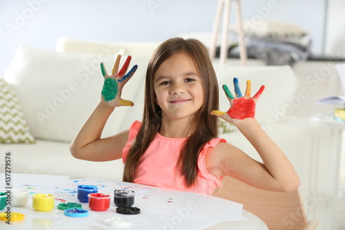 Cute little girl with paint...