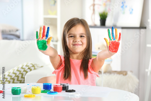 Cute little girl with paint...