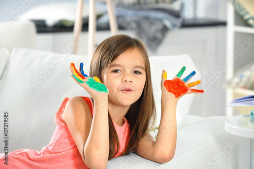 Cute little girl with paint...