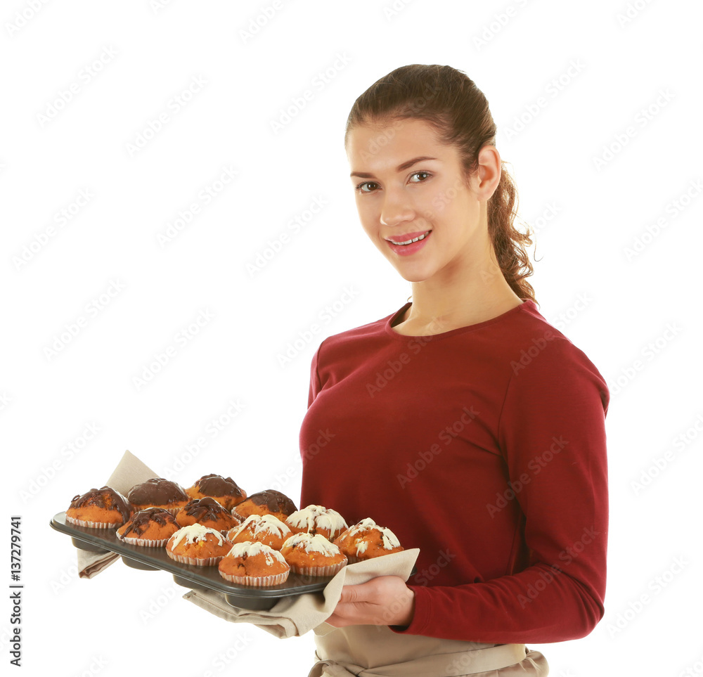 Woman in apron holding tray with chocolate muffins on white background Woman in apron holding tray with chocolate muffins on white background