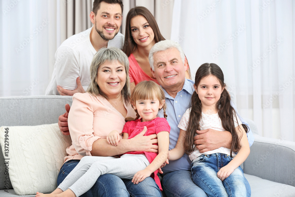 Happy family sitting on sofa in the room