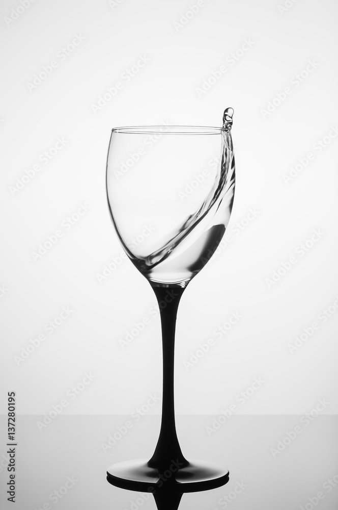 Water splashing in wine glass on white background Water splashing in wine glass on white background