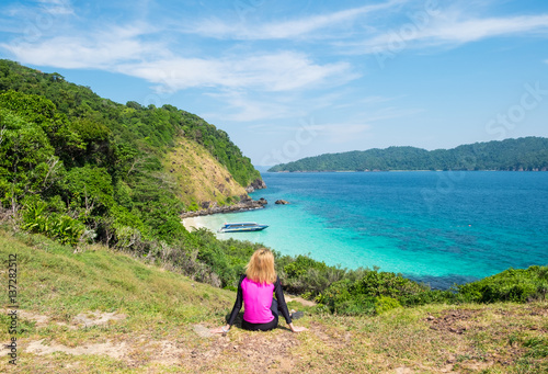 Young girl sits on a cliff,The mountains and sea scenery with blue sky,Islands: Lord Loughborough ,Myanmar
