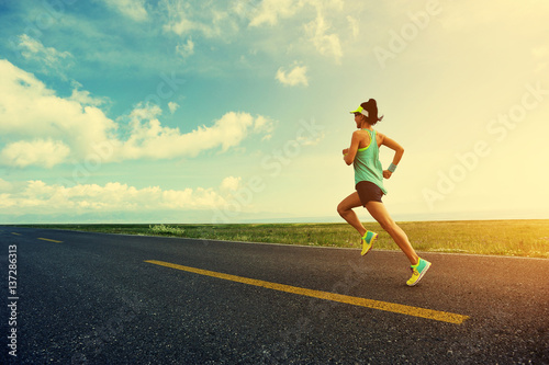 young fitness woman trail runner running on road