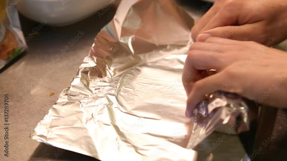 An Asian man preparing Mexican food, making delicious burritos in the kitchen of a Mexican restaurant-Dan An Asian man preparing Mexican food, making delicious burritos in the kitchen of a Mexican restaurant-Dan