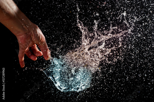 Bild auf Leinwand Burst of a balloon filled with water on black background