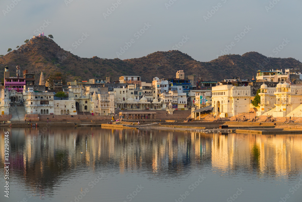 Cityscape at Pushkar, Rajasthan, India. Temples, buildings and ghats reflecting on the holy water of the lake at sunset. Cityscape at Pushkar, Rajasthan, India. Temples, buildings and ghats reflecting on the holy water of the lake at sunset.