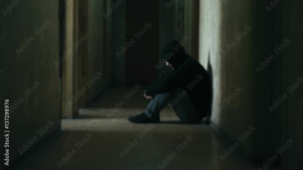Following a hooded young man inside a dark derelict ghetto building,slow motion dramatic Following a hooded young man inside a dark derelict ghetto building,slow motion dramatic