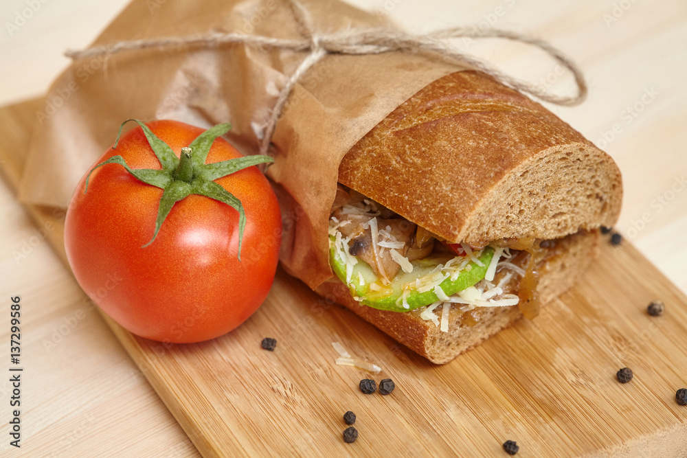 Big sandwich on wooden cutting board with ingridients Big sandwich on wooden cutting board with ingridients