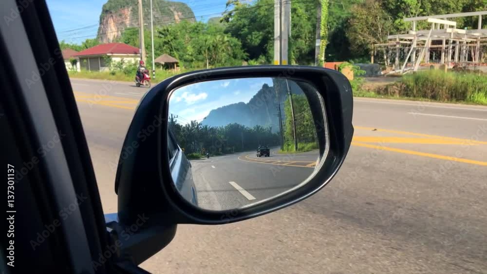 View of Side Mirror Reflection with Mountain and Highway. Travel by Car in Krabi, Thailand. HD. View of Side Mirror Reflection with Mountain and Highway. Travel by Car in Krabi, Thailand. HD.