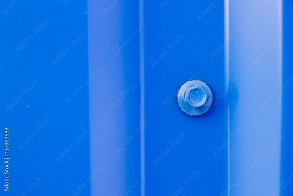 Bolt screwed in blue metal profiled sheet Bolt screwed in blue metal profiled sheet