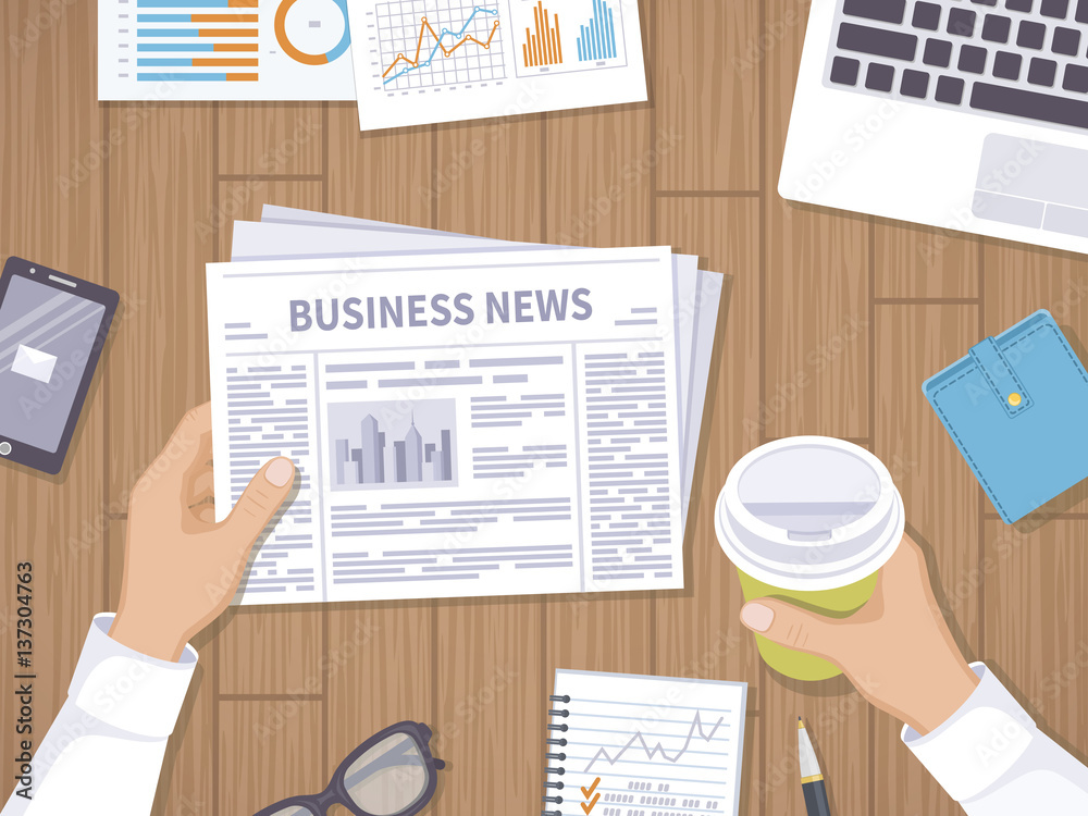 Obraz premium Business news. Businessman holding a newspaper and coffee to go on the wooden desktop. Coffee break, breakfast, lunch, documents, laptop, phone, purse, notebook. View from above