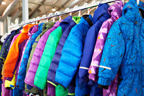 Winter children sports jacket on hanger in store photo