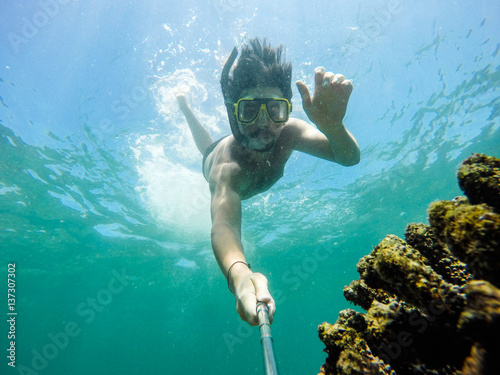 Fototapeta Naklejka Na Ścianę i Meble -  Underwater selfie shot with selfie stick.