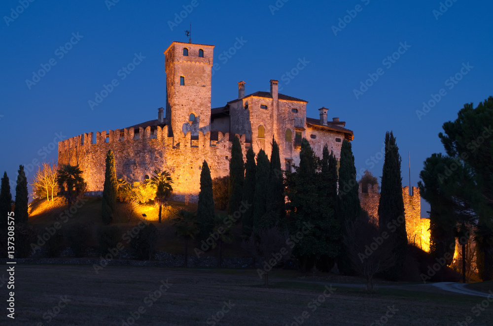 Castle of Villalta with the tower of Fagagna and the Alps in the background during the blue hour after the sunset, Friuli, Italy


