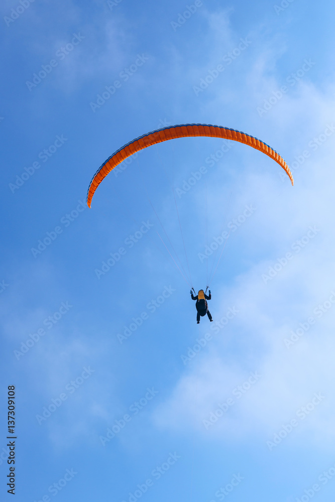 Paragliding in Ukraine over the against clear blue sky Paragliding in Ukraine over the against clear blue sky
