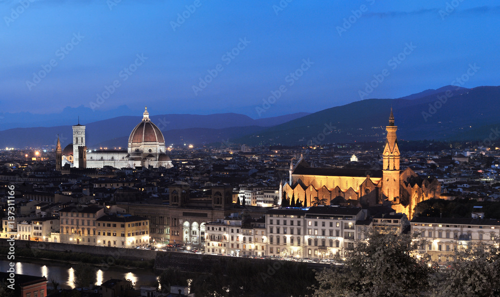 Evening sky and lights illuminate medieval buildings and Palazzo Vecchio and Duomo Santa Maria Del Fiore in Florence, Tuscany, Italy