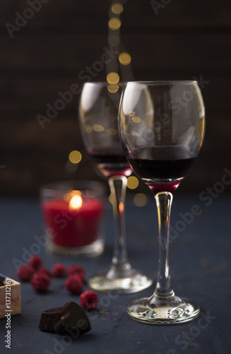 Festive glass of wine with chocolate candies