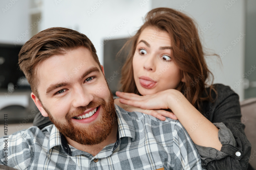 Funny couple sitting on sofa Funny couple sitting on sofa