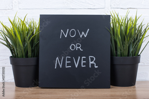 text now or never on blackboard photo