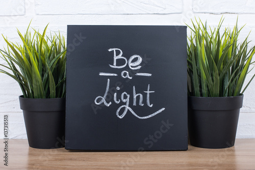 text be a light on blackboard photo