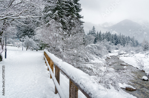 Cloudy view of river valley between Canazei and Campitello of Val di Fassa, Trentino-Alto-Adige region, Italy. photo