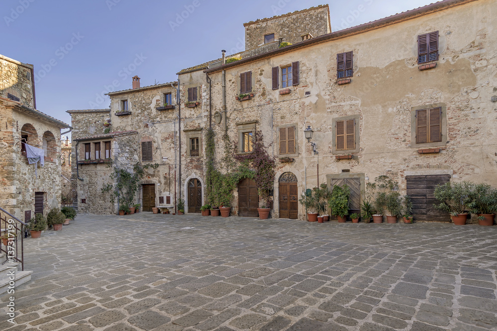 Fototapeta premium The wonderful Piazza del Castello square in the historic center of Montemerano, Grosseto, Tuscany, Italy