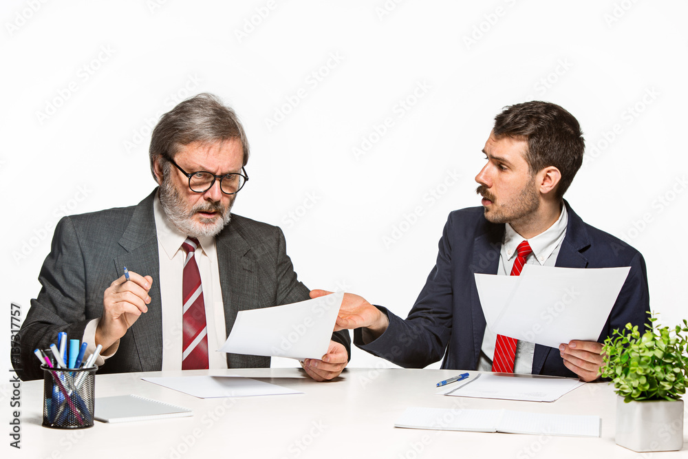 The two colleagues working together at office on white background. The two colleagues working together at office on white background.