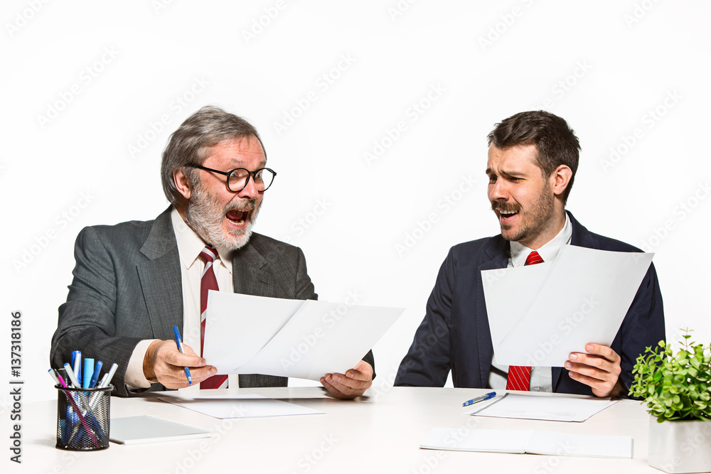 The two colleagues working together at office on white background. The two colleagues working together at office on white background.