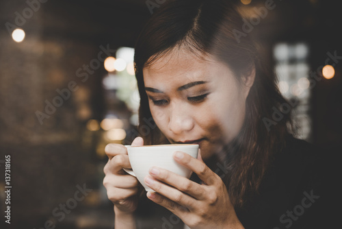 Young woman relaxing drinking coffee at cafe.