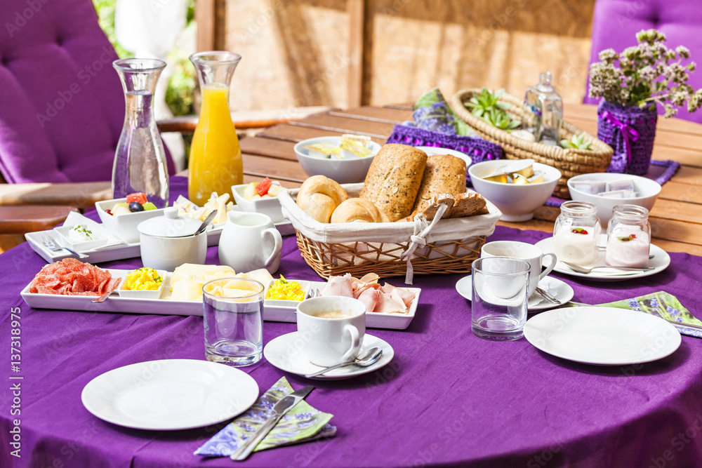 Fototapeta premium Fresh Breakfast or brunch with ham, eggs, bread, yogurt, fruits and coffee