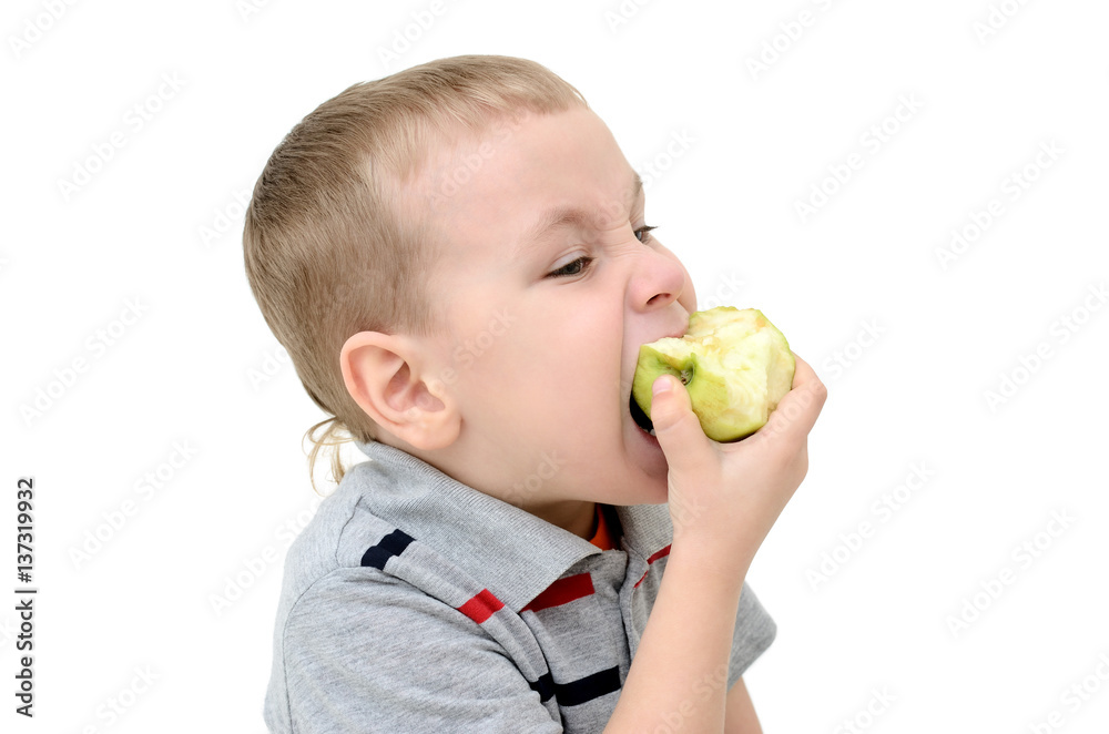Boy eating an apple on a white background Boy eating an apple on a white background