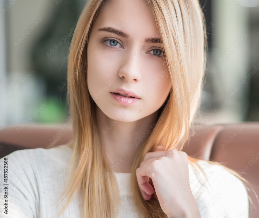 Portrait of a beautiful young woman with blue eyes.