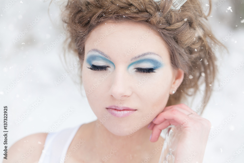 Winter woman, queen of snow - beautiful girl in winter makeup Winter woman, queen of snow - beautiful girl in winter makeup