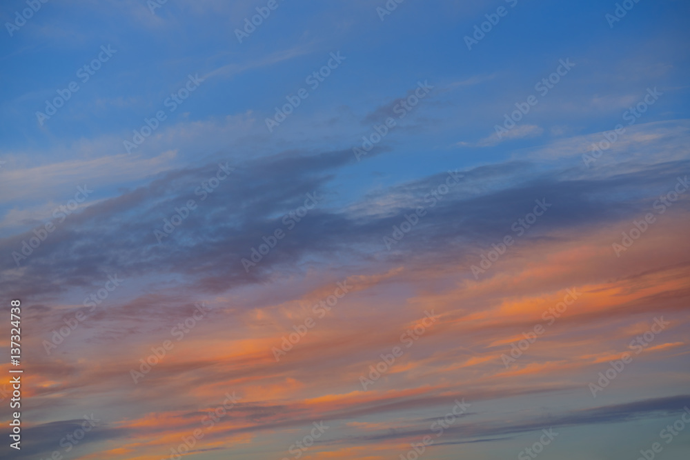 Sunset sky orange clouds over blue