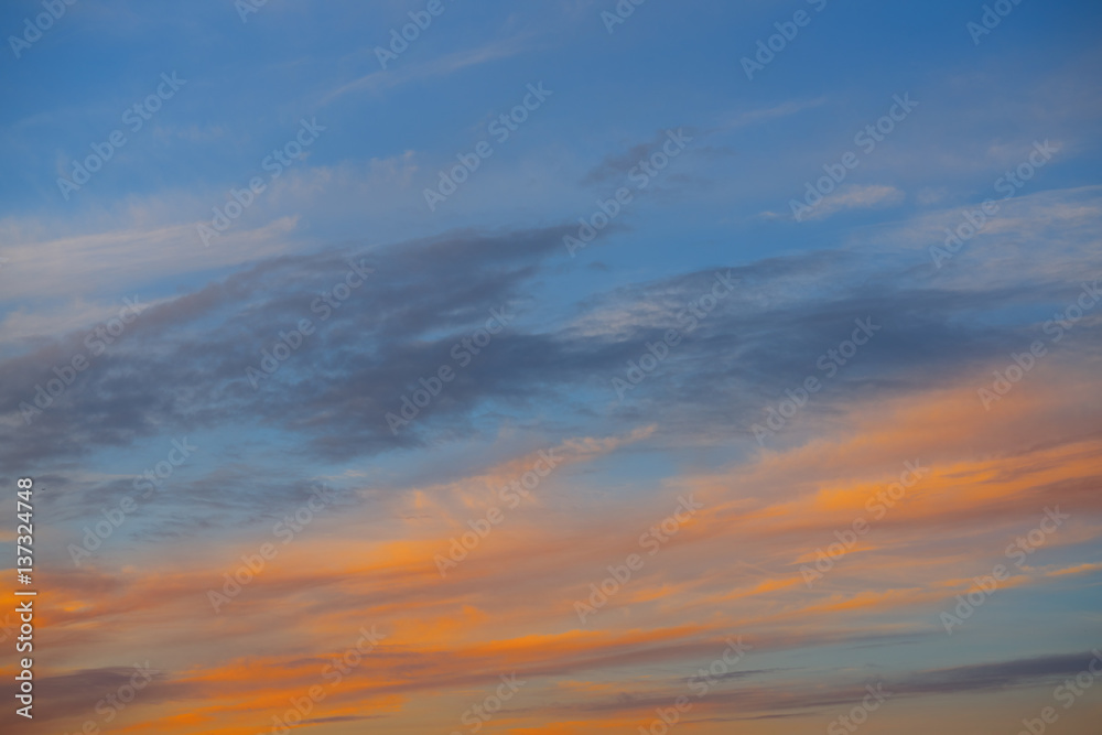Obraz premium Sunset sky orange clouds over blue