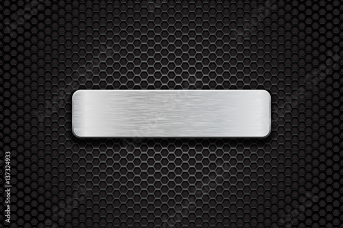 Metal brushed plate on perforated dark steel background