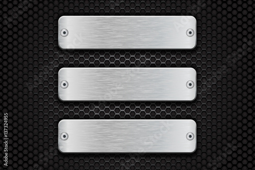 Metal brushed plate on perforated dark steel background