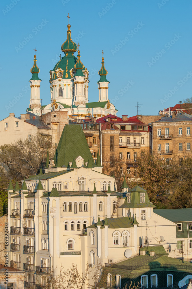 Famous St Andrew church and descent with artistic fare in Podol, historic district of Kiev
