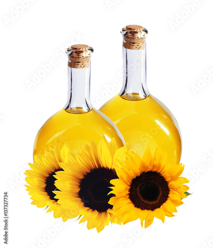oil in bottles and sunflowers, isolated on white
