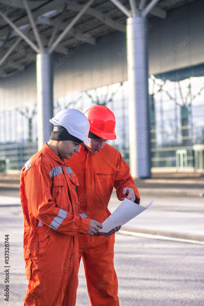 team of young engineers discussing construction project team of young engineers discussing construction project