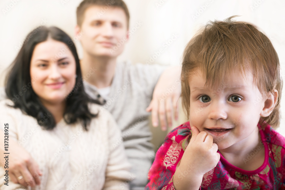 little smiling child girl with the parents at the distance little smiling child girl with the parents at the distance