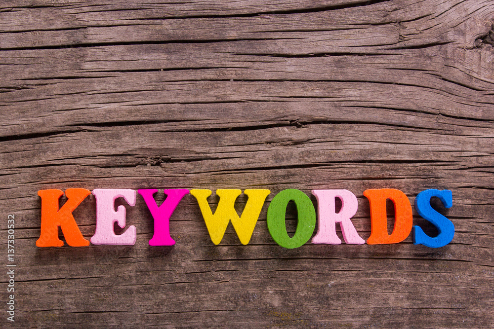 Fototapeta premium keywords word made from colored wooden letters on an old table. Concept