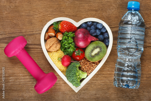 Healthy food in heart shaped bowl photo